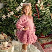 Photo d'un enfant portant la jupe rose en tulle souple, enfant
