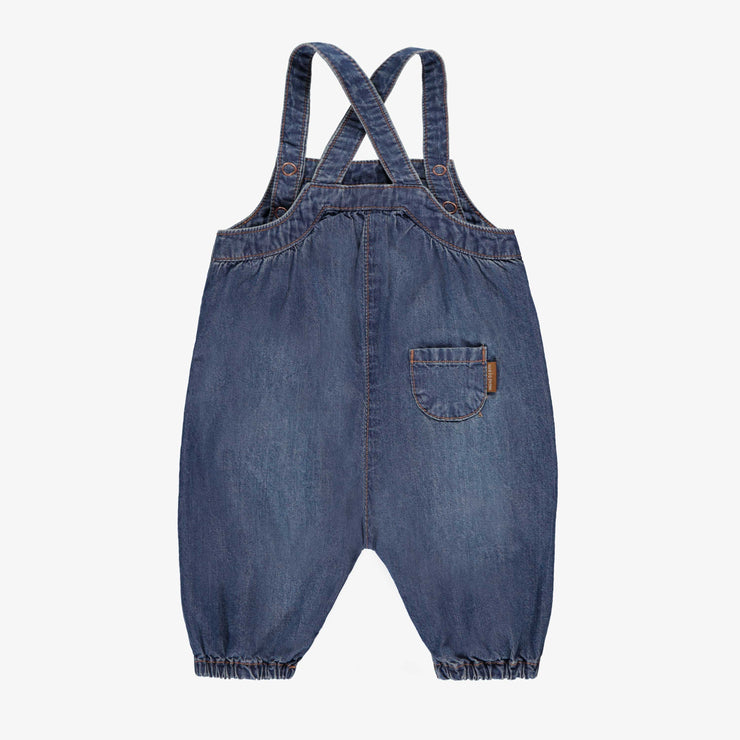 Salopette bleue en denim, naissance