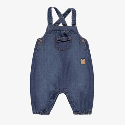 Salopette bleue en denim, naissance