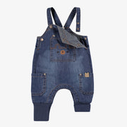 Salopette bleue en denim, naissance