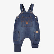 Salopette bleue en denim, naissance