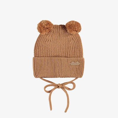 Tuque brune en tricot avec pompons, naissance