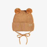 Tuque brune en tricot avec pompons, naissance