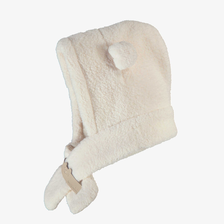 Côté du chapeau crème en sherpa, naissance